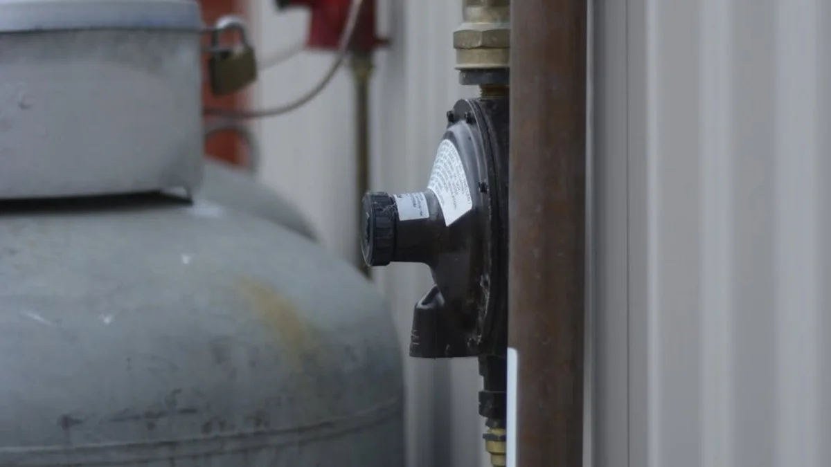 Gas plumbing service Adelaide — LPG gas cylinder with pressure regulator and copper pipe connections