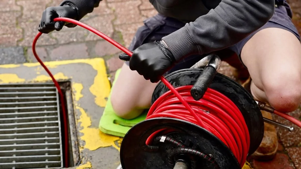 Sewer repair service Adelaide — plumber using high-pressure water jetting to clear a blocked sewer drain