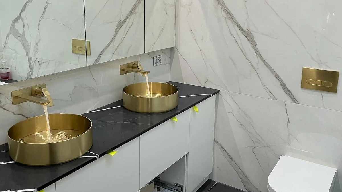 Water pressure repair Adelaide — luxury bathroom with gold basin taps flowing at correct pressure